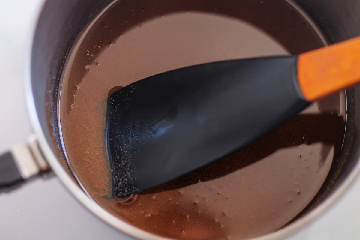 Sugar and oil being stirred in a pan.