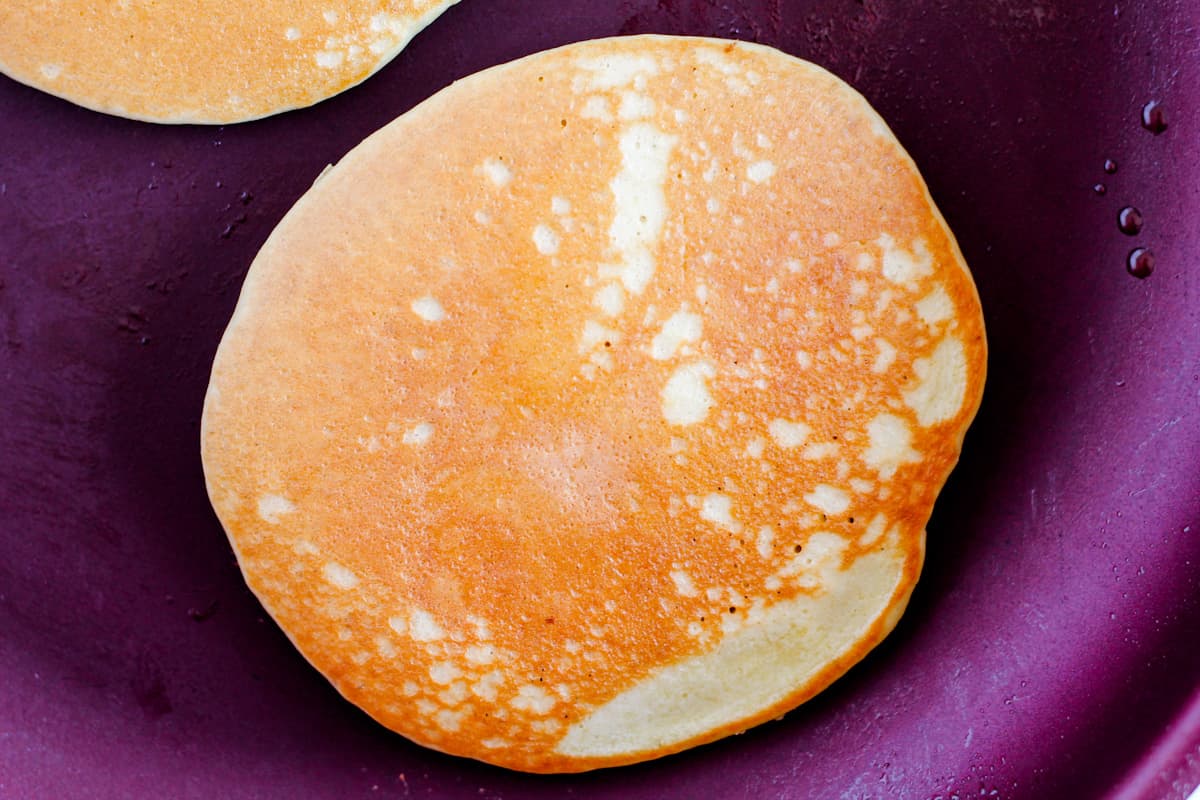 A golden brown pancake in a skillet.