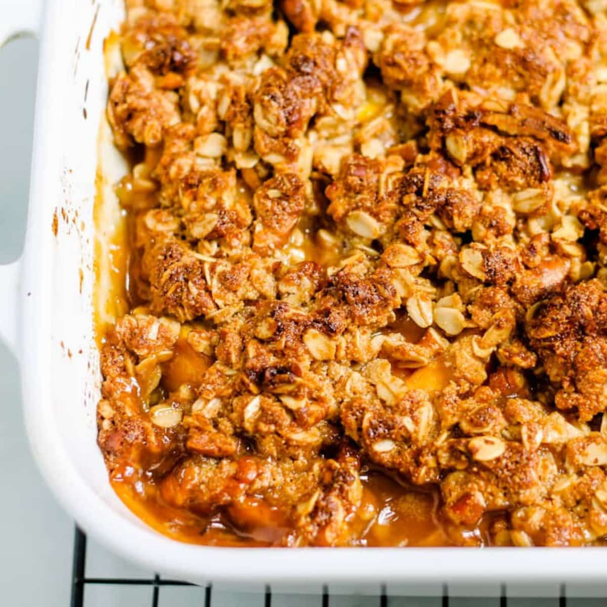 Freshly baked peach crisp in a baking dish.