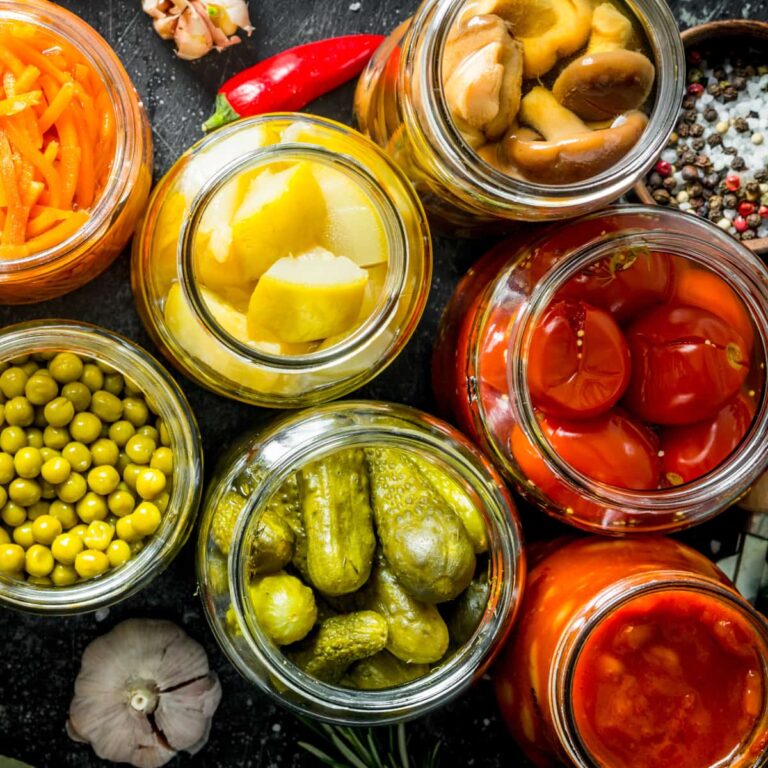 Jars of fruit and vegetables ready to be pickled.