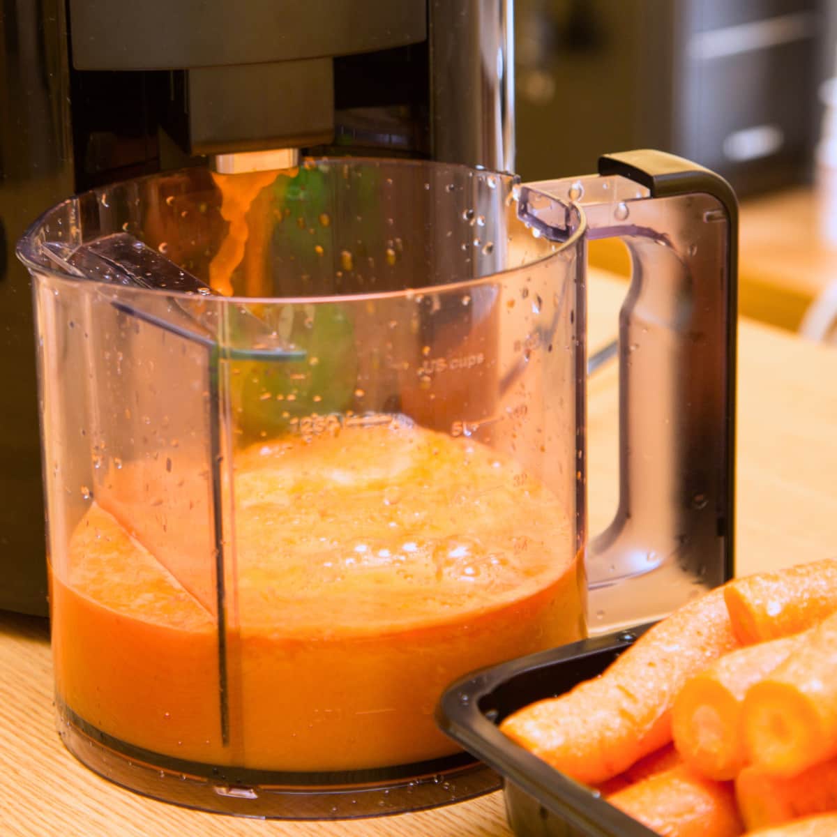 Fresh juice coming out of a juicer.