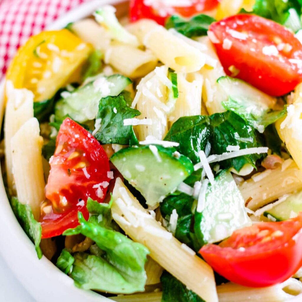 A pasta salad without mayo in a bowl.