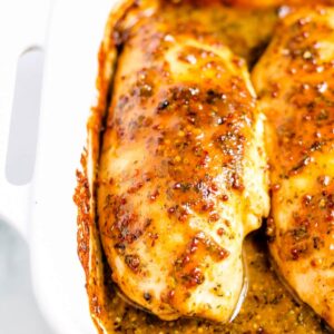 A dish of baked honey mustard chicken resting on a rack.