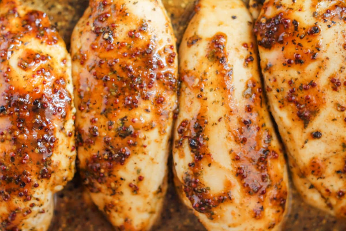 Overhead image of baked honey mustard chicken in a dish.