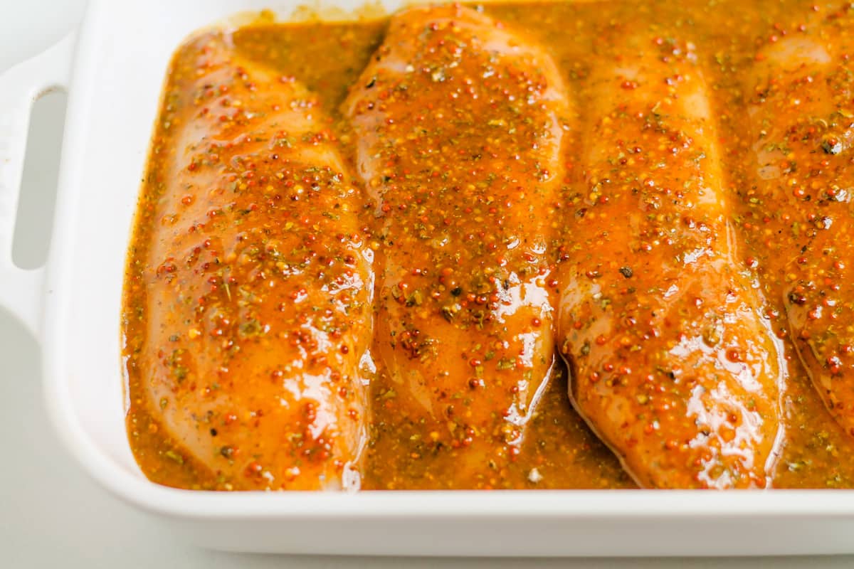 Chicken breasts covered in sauce.