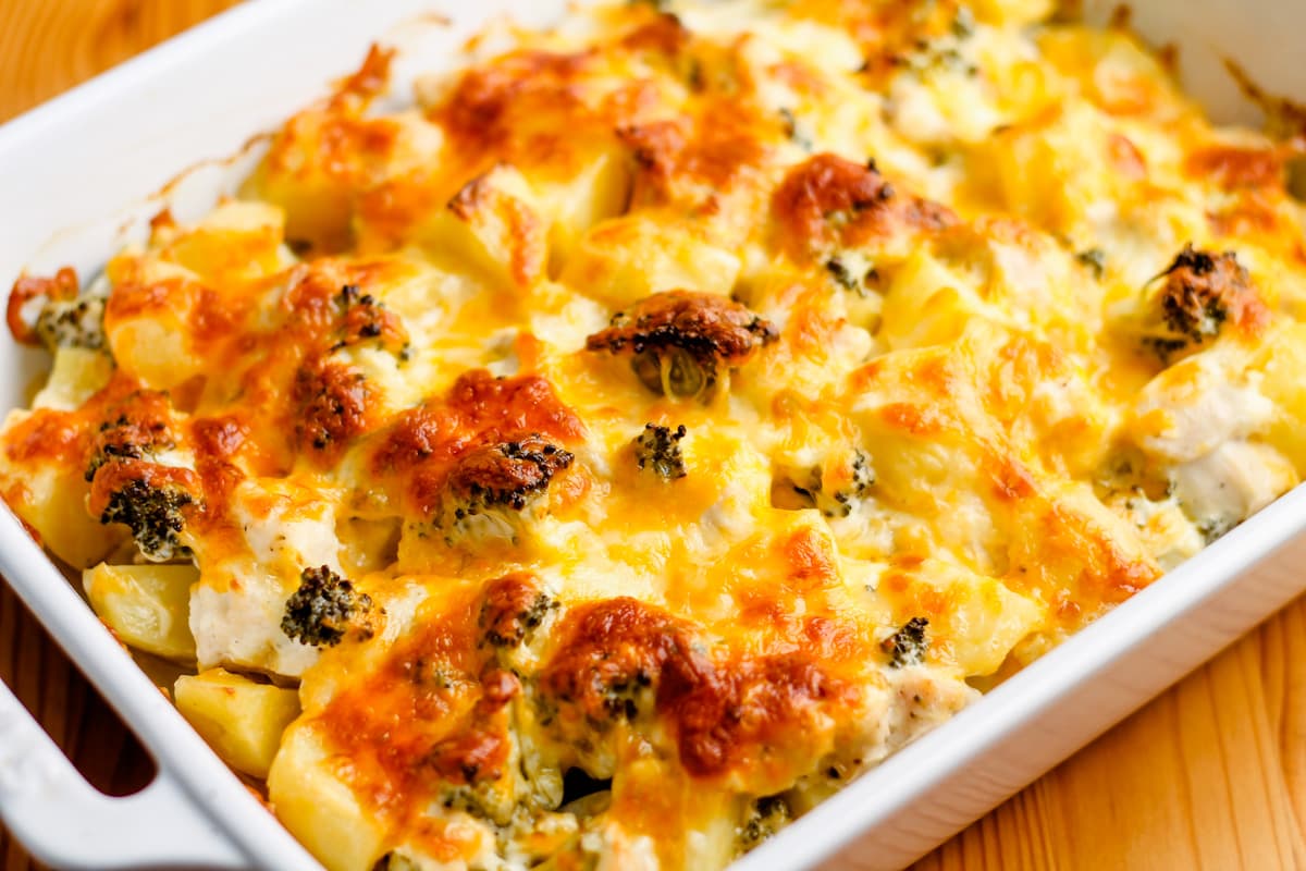 A baking dish with chicken broccoli potato casserole.