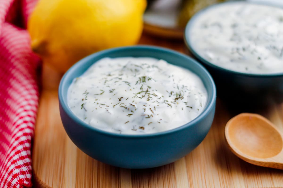 A small side dish of healthy tartar sauce on a counter.