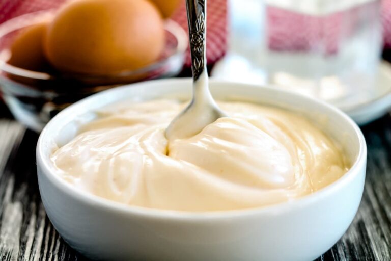 Homemade mayo being stirred in a small bowl.