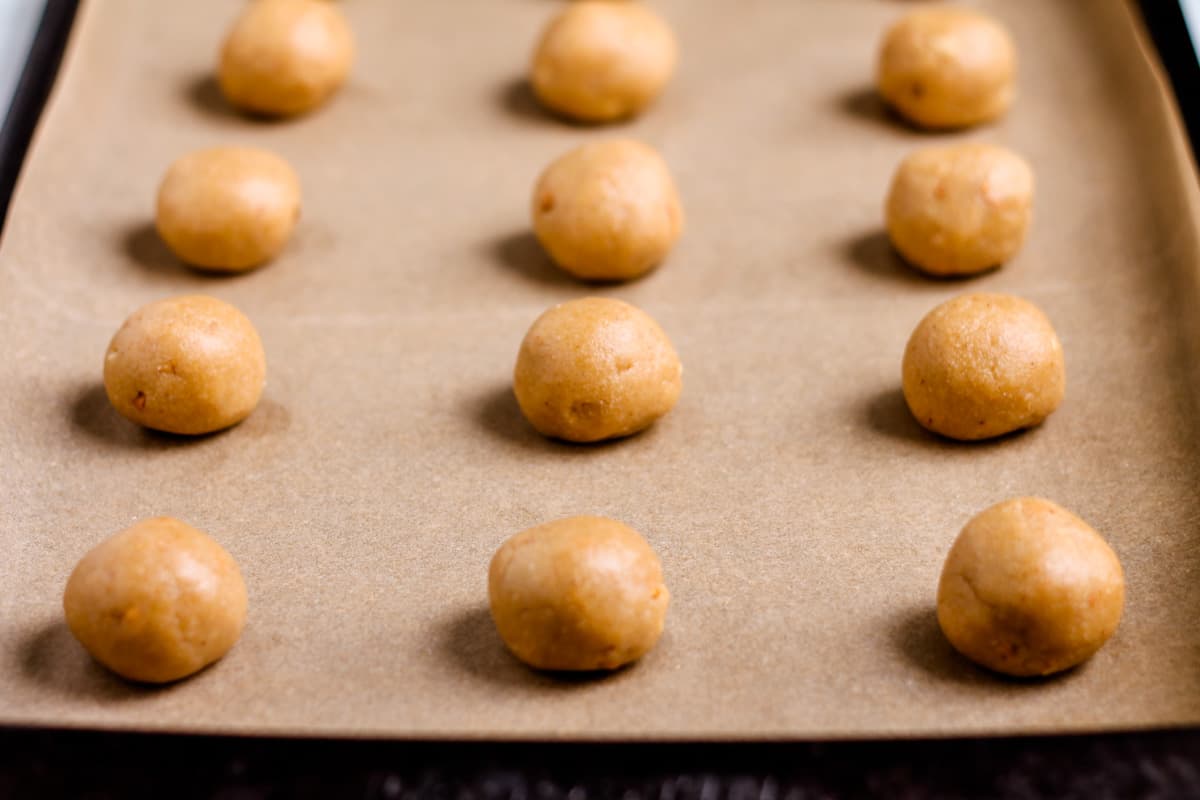 Dough balls on a baking tray.