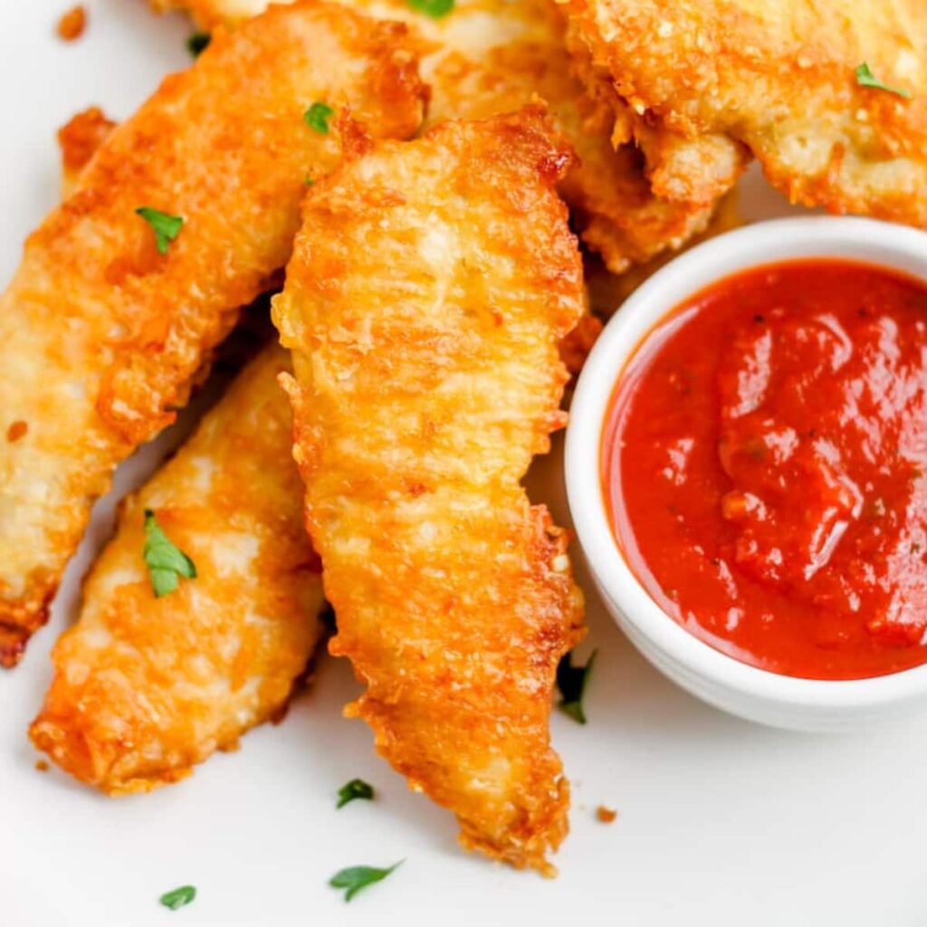 A plate of oven baked parmesan chicken tenders.