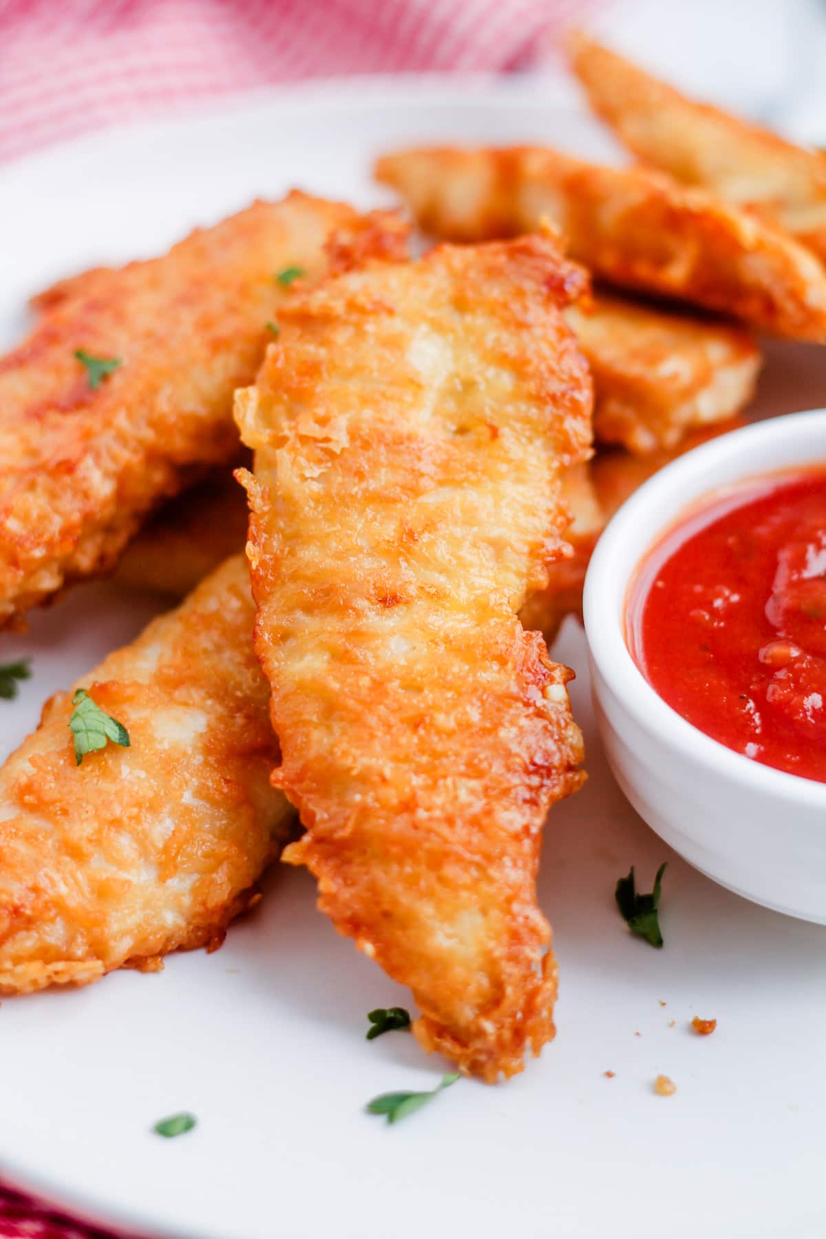 A plate of baked parmesan chicken tenders.