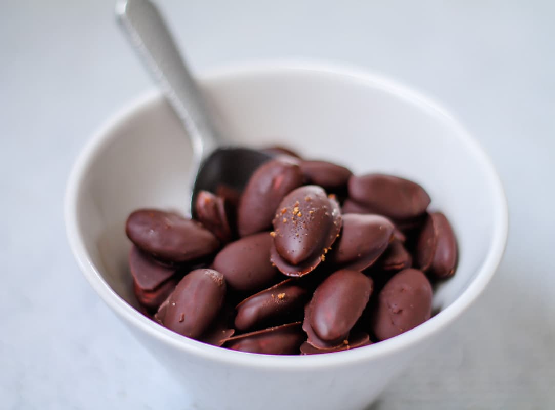 A bowl of homemade chocolate covered almonds.