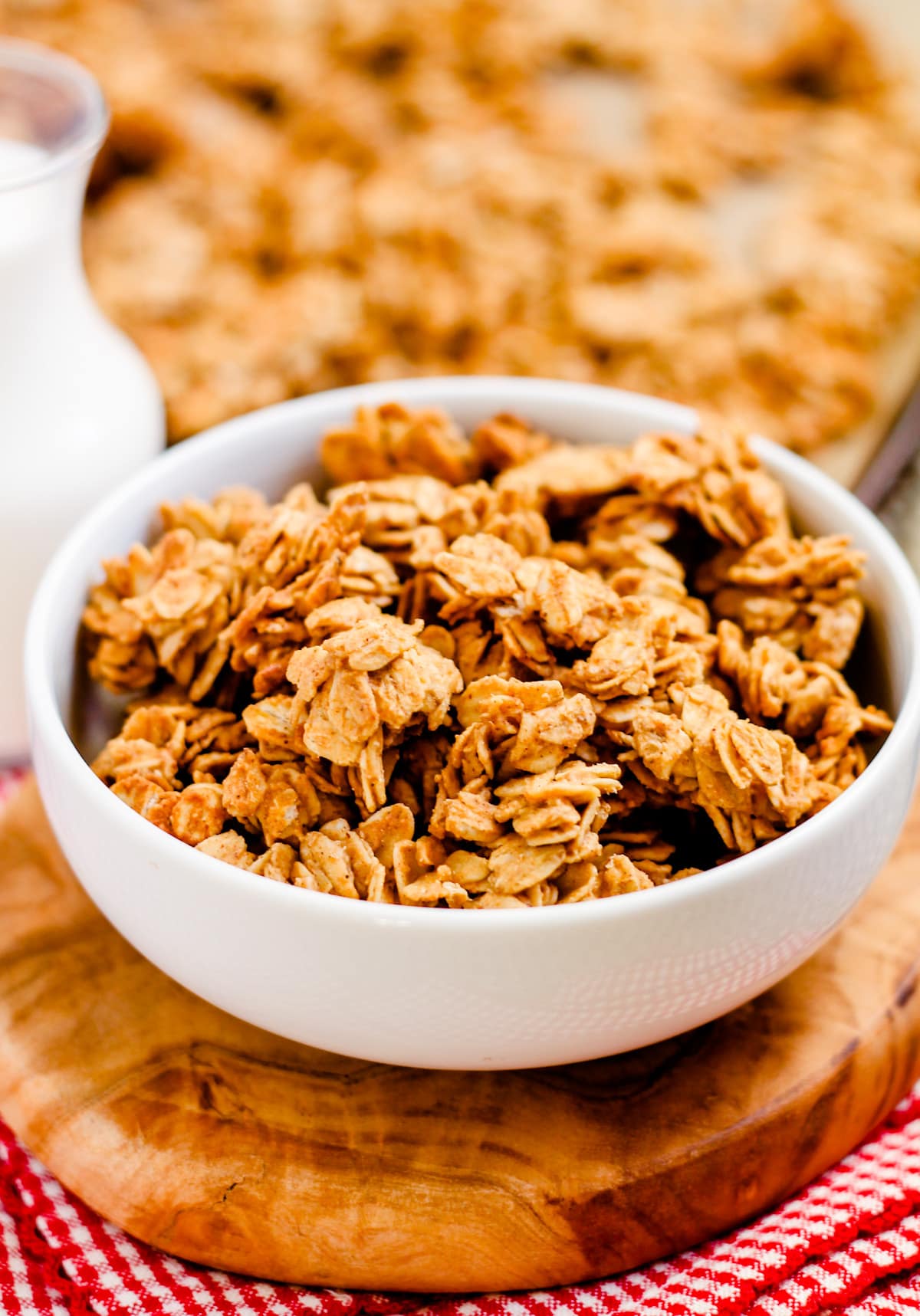 A bowl of easy homemade granola with a glass of milk behind it.