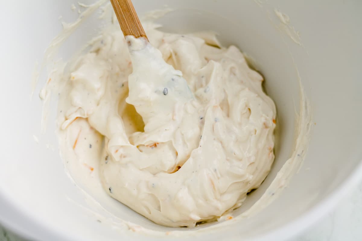 A creamy mixture being stirred in a bowl.