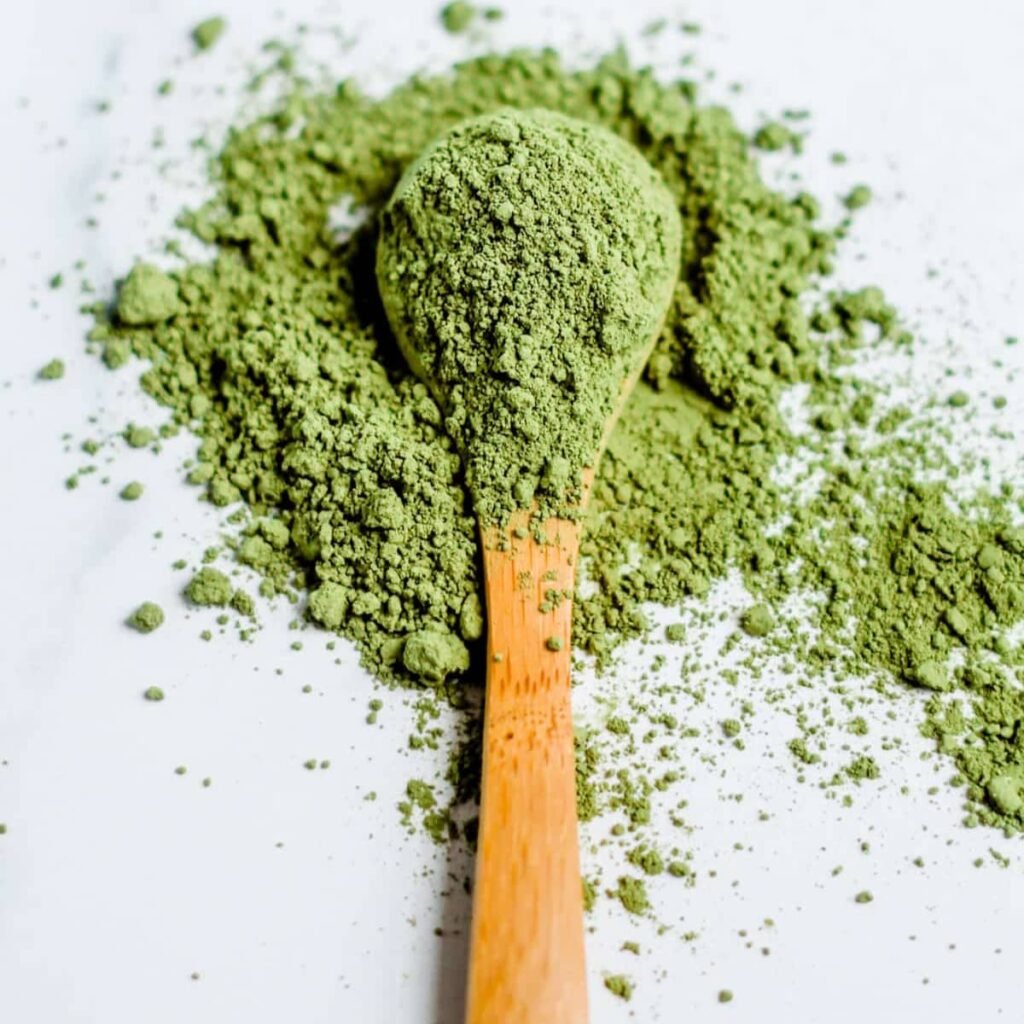 A spoonful of green matcha tea powder.