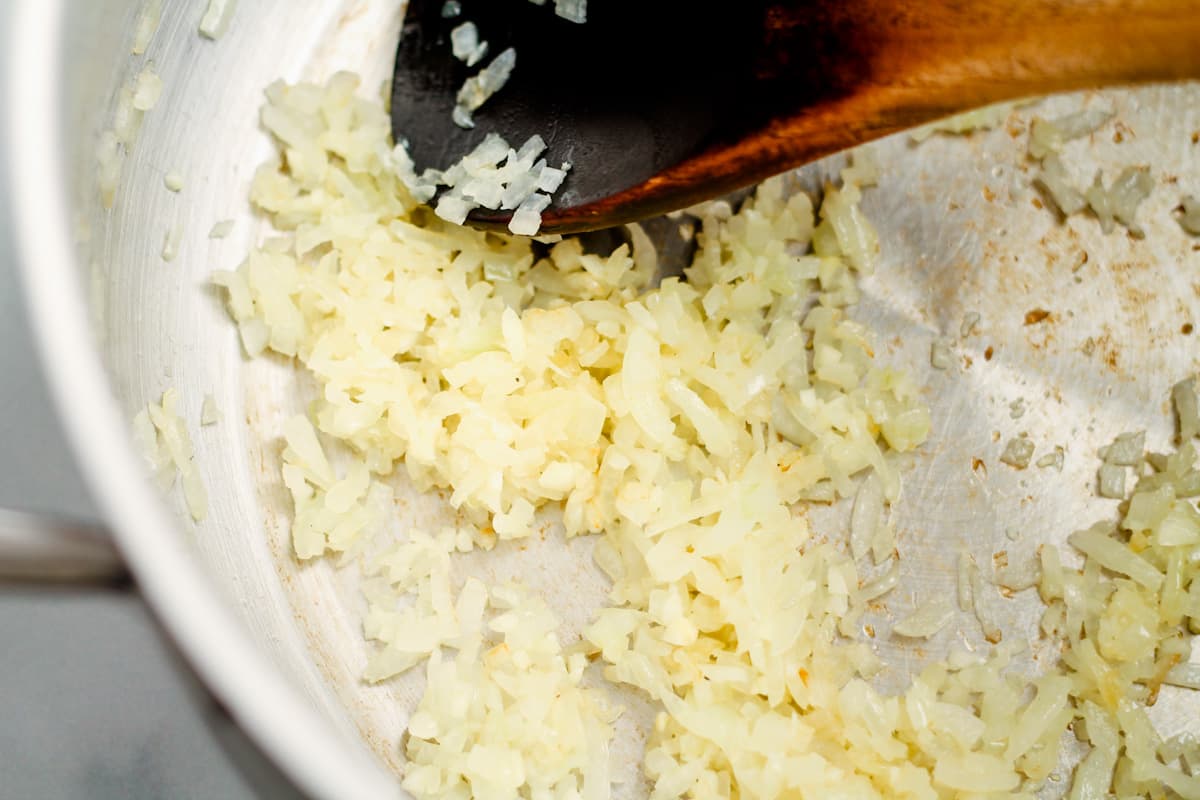 Onions and garlic cooking in a pan.