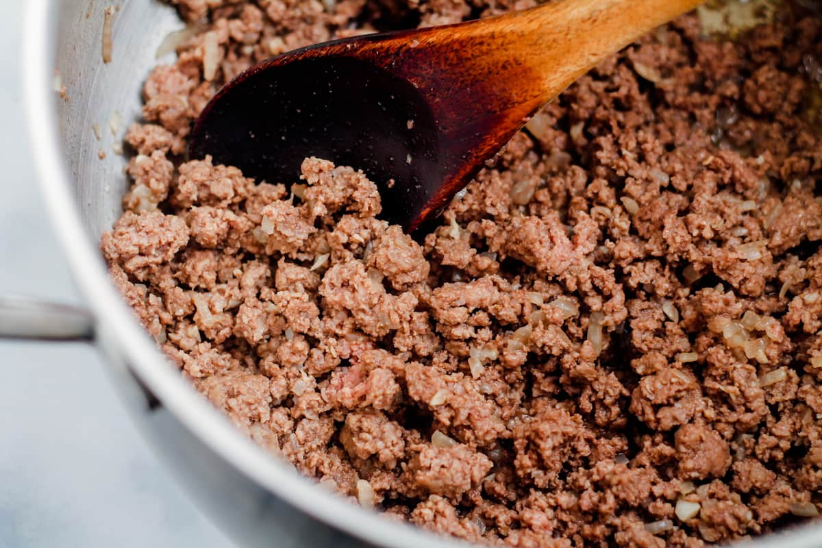 Beef browning in a pan.