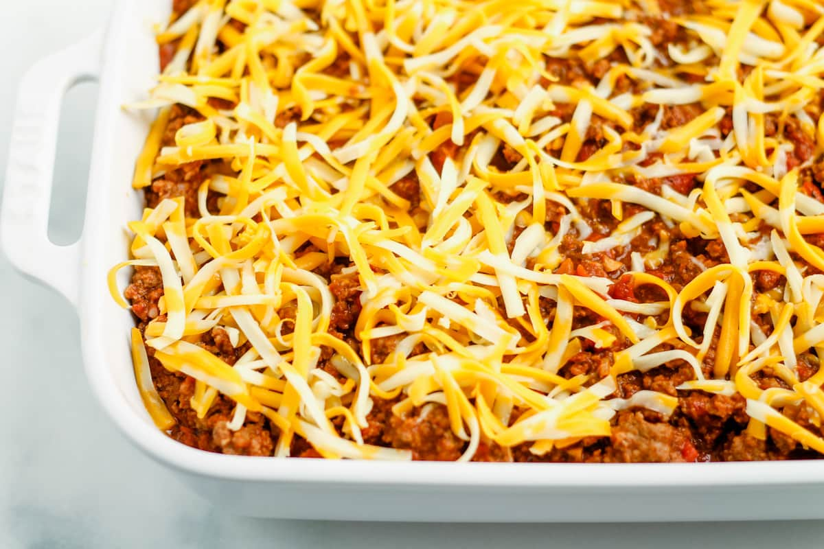 Shredded cheese sprinkled on top of beef mixture.