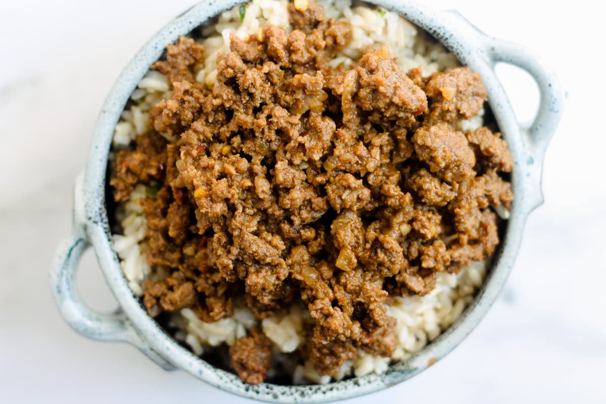 Spiced beef on top of rice in a bowl.