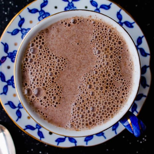 Overhead image of a mug of warm almond milk.