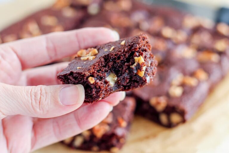 A hand holding a gluten free brownie.