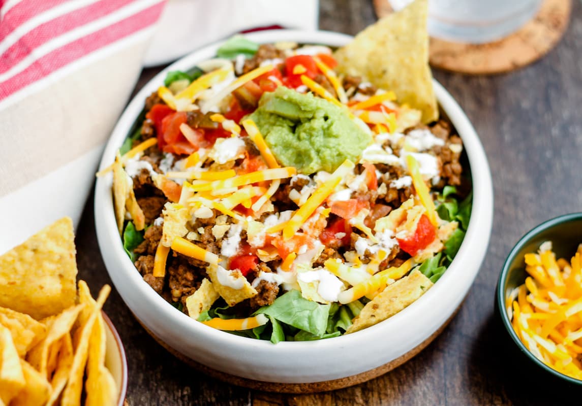 A healthy taco salad topped with guacamole.