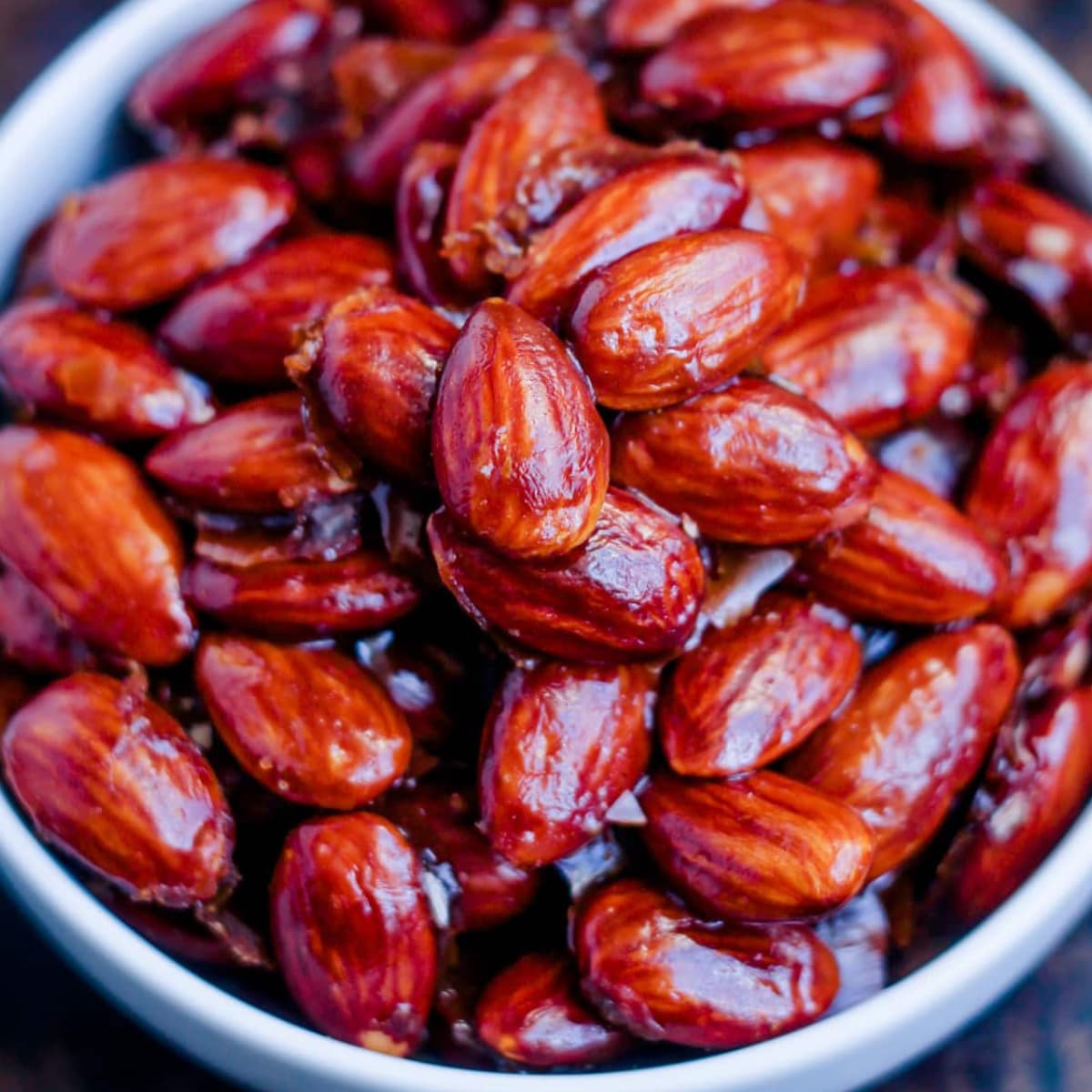 A bowl of butter toffee almonds.