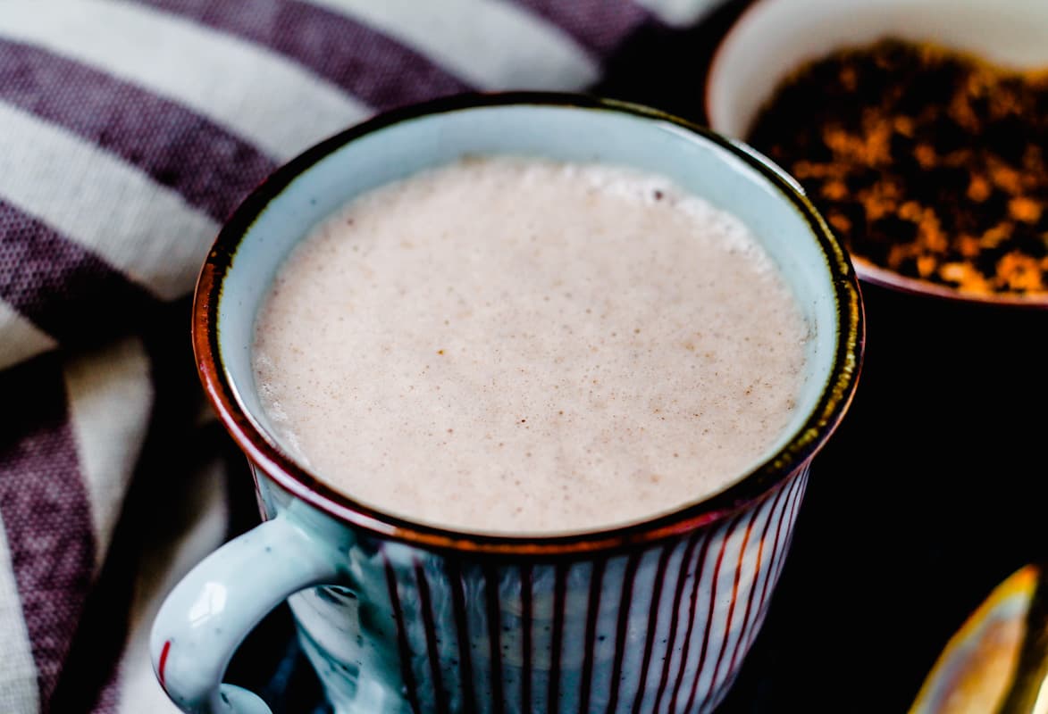 A mug of chaga hot chocolate on a table.