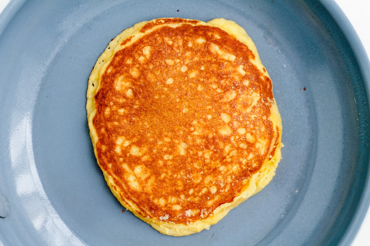 A cooked pancake on a pan.