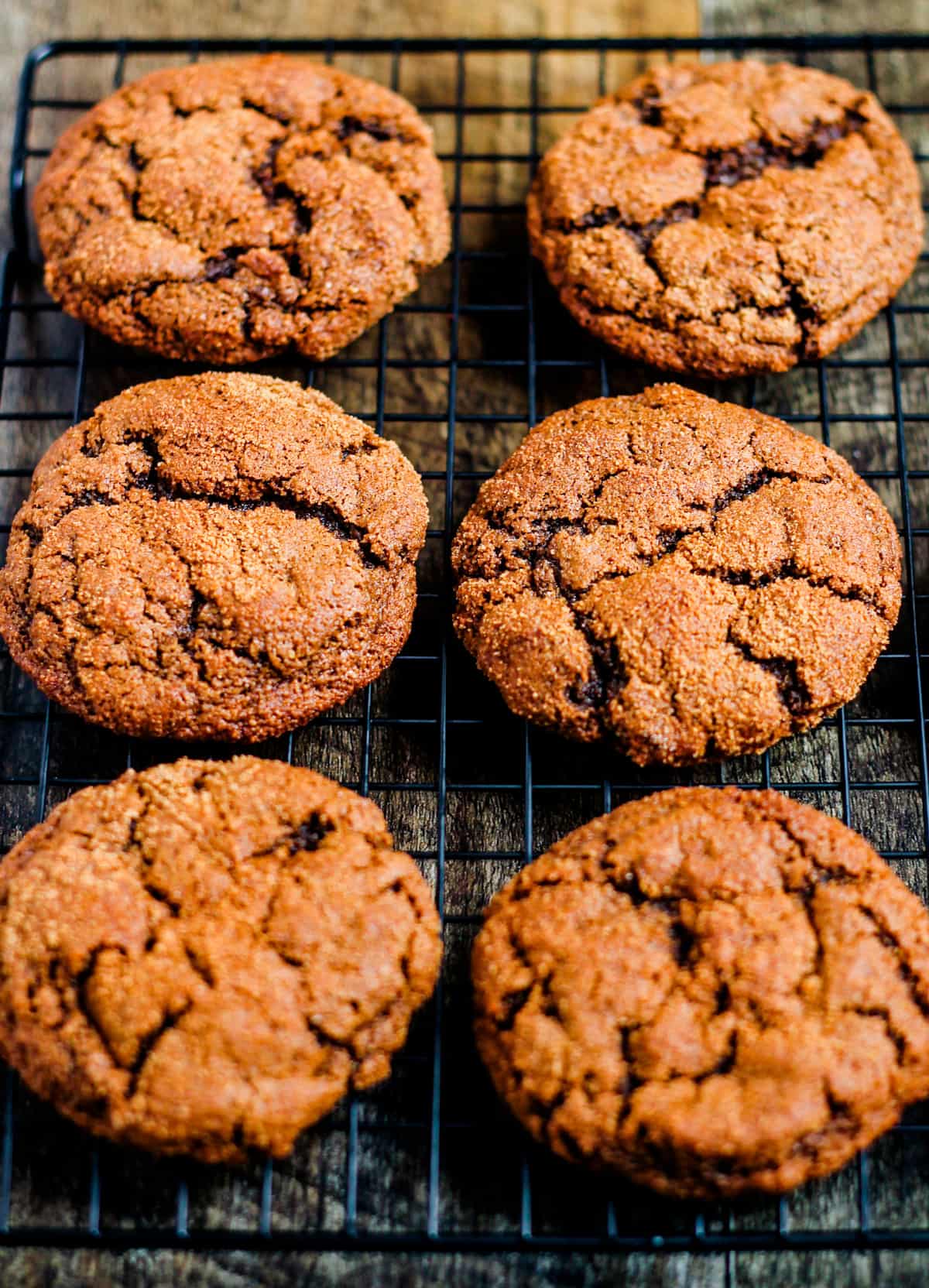 A wire rack filled with gluten free ginger molasses cookies.