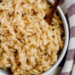Overhead image of brown rice cooked in broth.