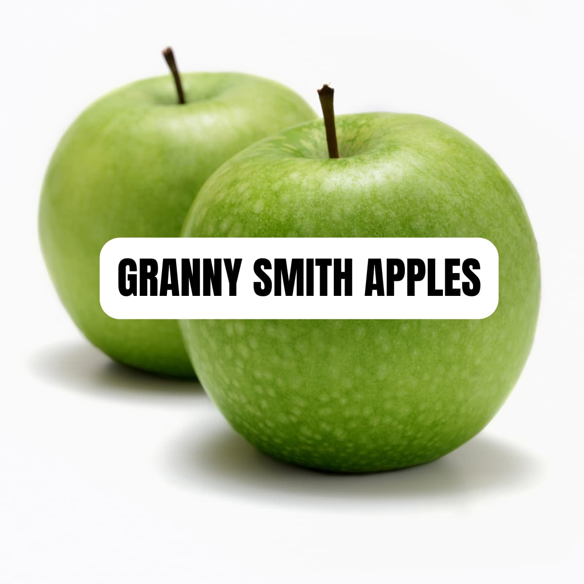 Two granny smith apples on a counter with text overlay.