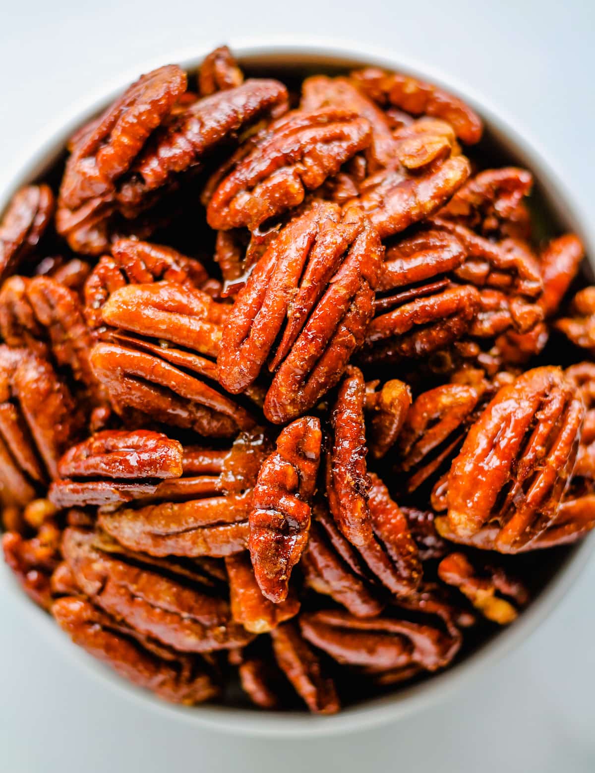 Overhead image of a bowl of spicy candied pecans.