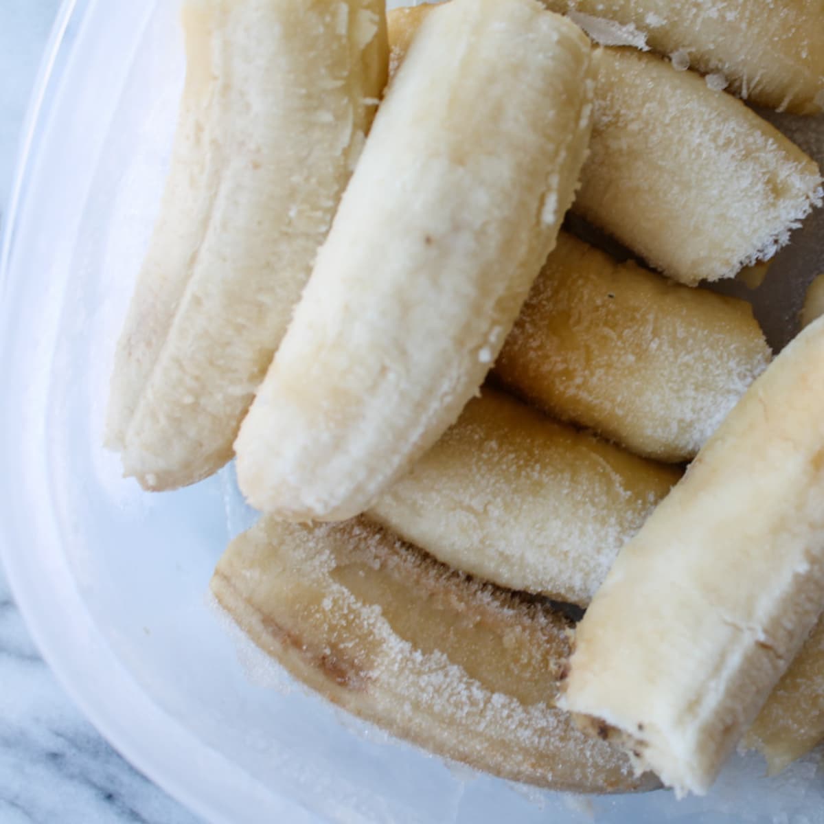 Frozen bananas in a container.