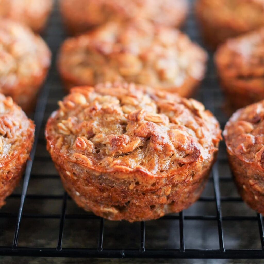 Banana oat muffins on a wire baking rack.