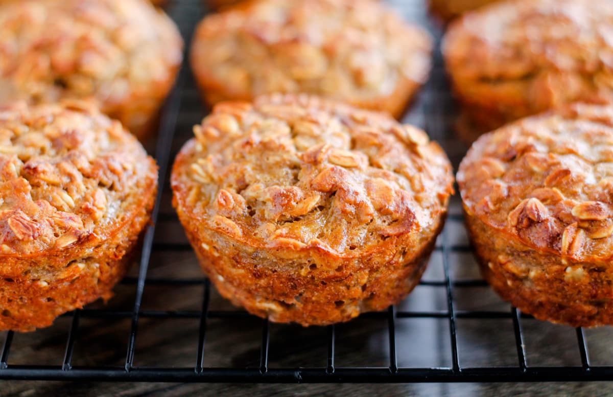 Banana oat muffins on a wire baking rack.