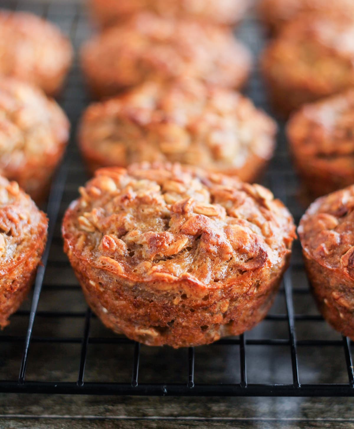 Banana oat muffins on a wire baking rack.