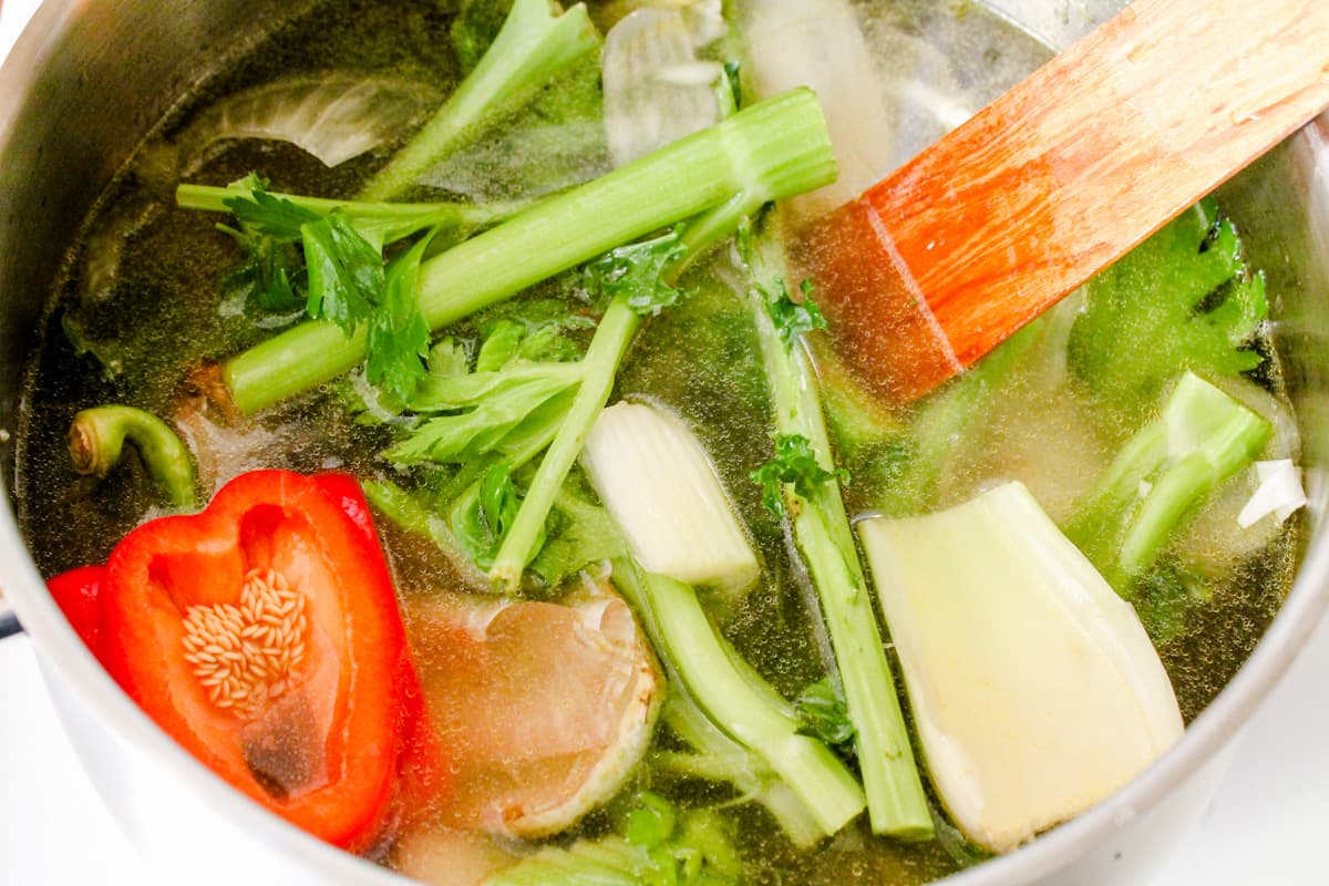 Ingredients being stirred in a soup pot.
