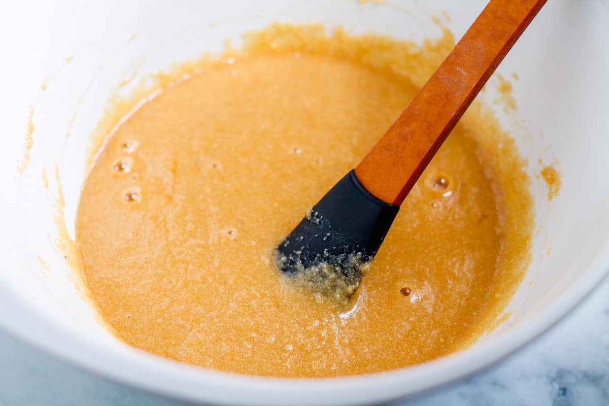 A spatula stirring ingredients in a bowl.