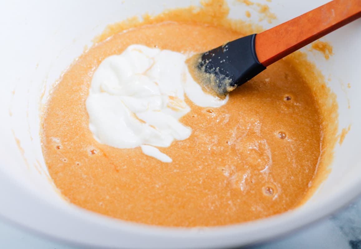 A spatula stirring ingredients in a bowl.