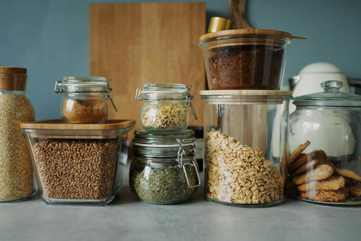 Jars on a shelf in a pantry.