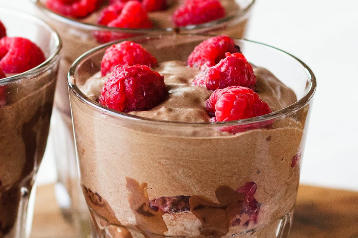 A glass of coconut chocolate pudding.