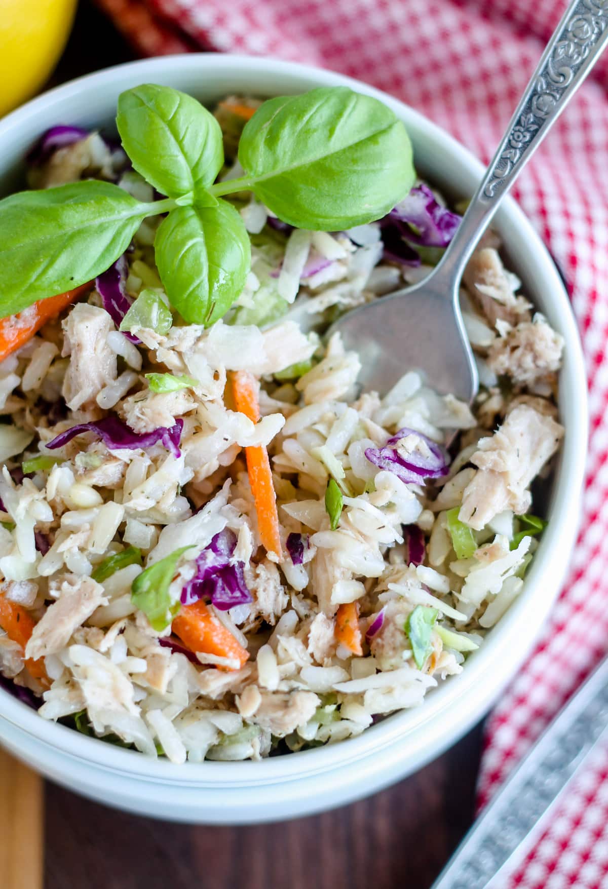 Overhead image of a bowl of rice salad with tuna with a fork in it.