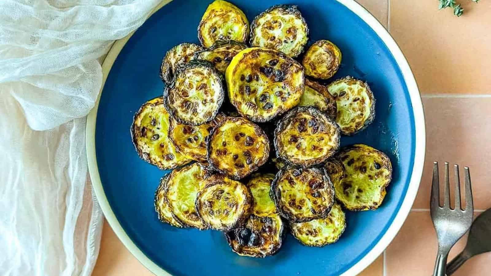 Air fryer zucchini and squash on a blue plate.