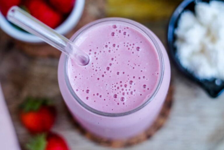 Overhead image of a cottage cheese smoothie in a glass.