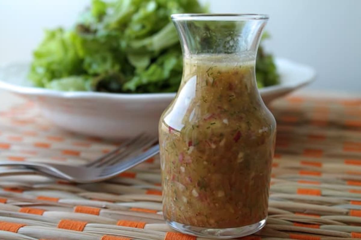 A jar of dill red onion dressing.