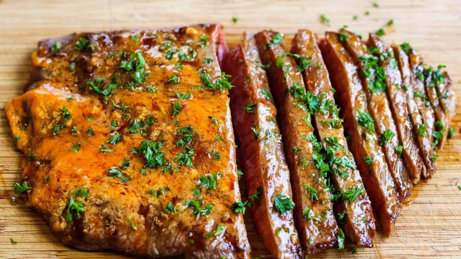 Sliced flank steak with chili butter.