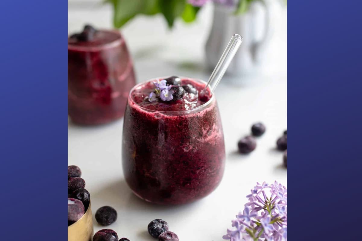 A glass of blueberry ginger kombucha.