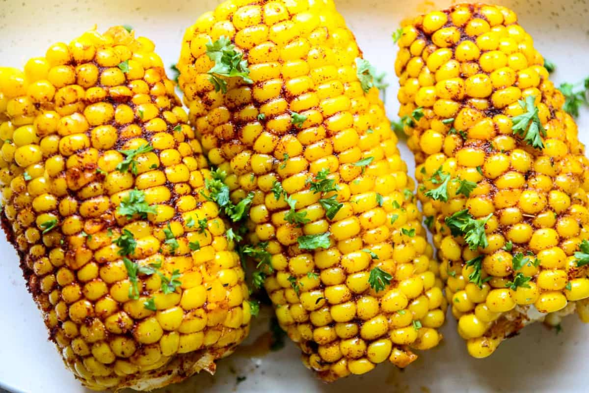 A plate of cajun corn on the cob.