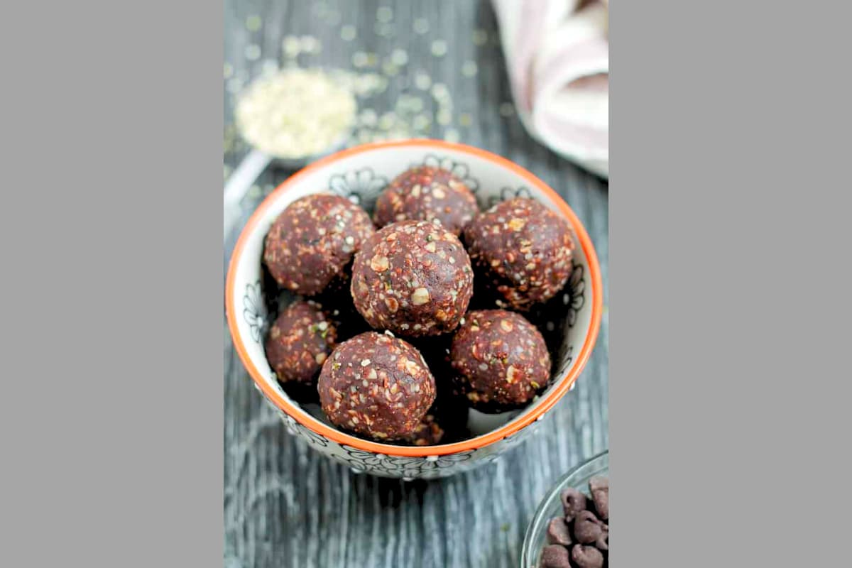 A bowl of chocolate peanut butter hemp seed balls.